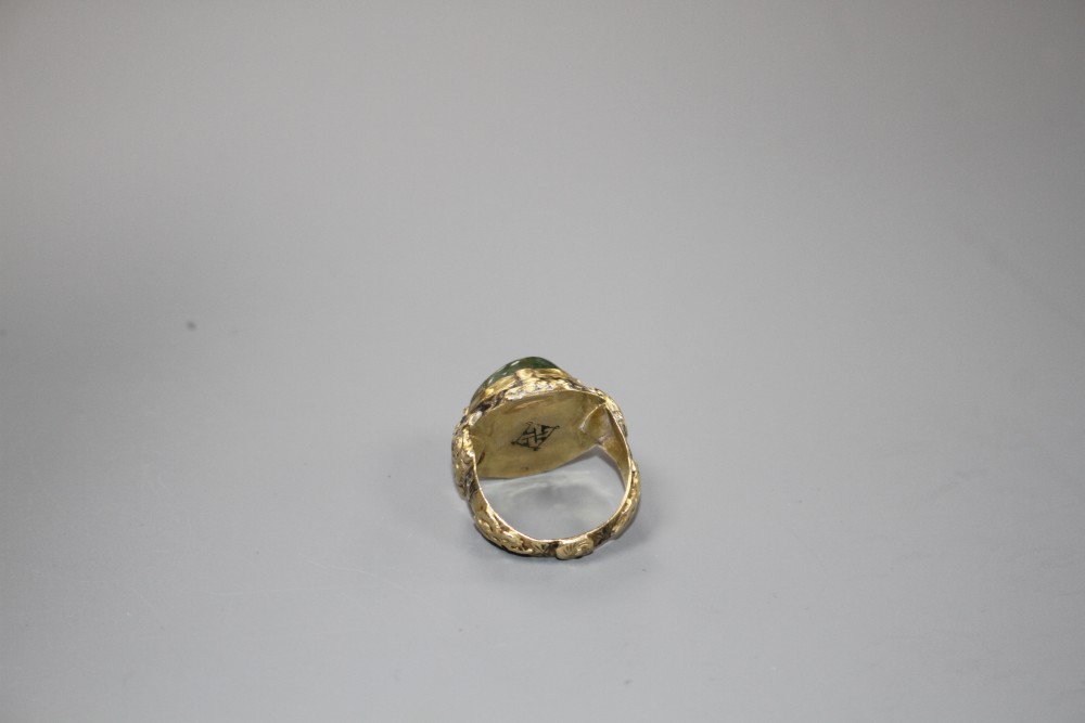 An antique yellow metal (tests as high carat), black enamel and cabochon emerald set ring, size G/H, gross weight 5.9 grams.